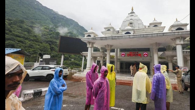 People at the entry gate for the Vaishno Devi Temple after the ‘yatra’ was temporarily suspended following a landslide and heavy rainfall, at Katra, in Reasi district, Jammu and Kashmir, Wednesday. (PTI Photo)