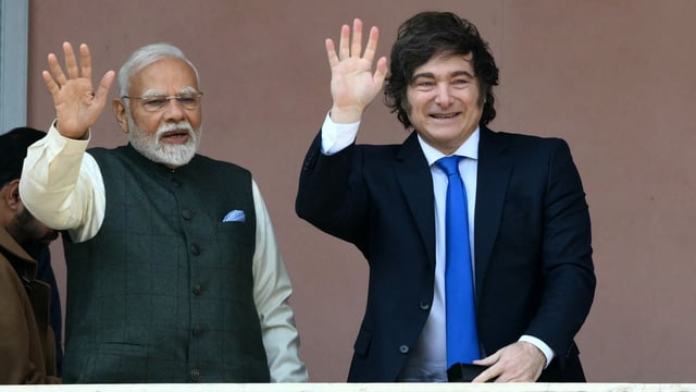 India's Prime Minister Narendra Modi (L) and Argentina's President Javier Milei wave on the balcony of the Casa Rosada government palace after a meeting in Buenos Aires, on July 5, 2025. 