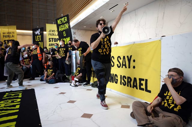 Noga Yechieli leads a chant as Jewish Bay Area residents stage a sit-in protest in the lobby of Sen. Alex Padilla’s office in San Francisco, calling for a stop to the Israel-Hamas war on Wednesday, Aug. 27, 2025.