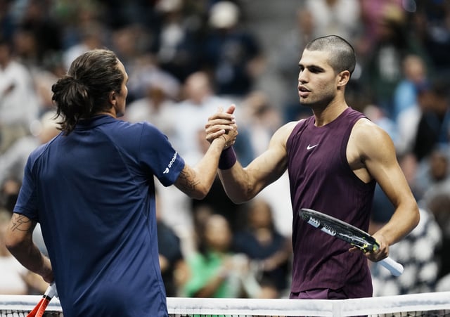 Tennis - U.S. Open - Flushing Meadows, New York, United States - August 27, 2025 Spain's Carlos Alcaraz shakes hands with Italy's Mattia Bellucci after winnig his second round match REUTERS/Eduardo Munoz
