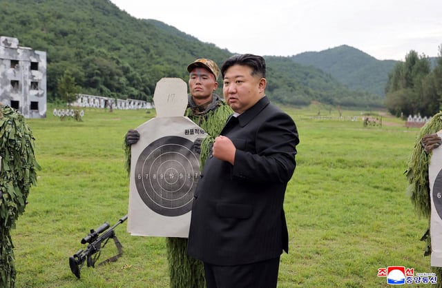 North Korean leader Kim Jong Un reacts while inspecting target sheets during a visit to a special operation training base at an undisclosed location in this undated picture released by North Korea's official Korean Central News Agency August 28, 2025.     KCNA via REUTERS