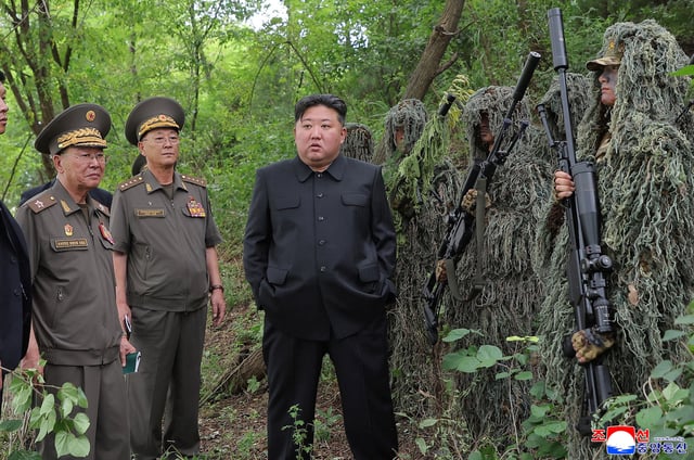 North Korean leader Kim Jong Un stands next to snipers during a visit to a special operation training base at an undisclosed location in this undated picture released by North Korea's official Korean Central News Agency August 28, 2025.     KCNA via REUTERS