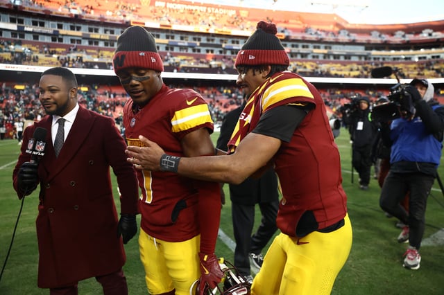 Terry McLaurin #17 and Jayden Daniels #5 of the Washington Commanders greet after defeating the Philadelphia Eagles at Northwest Stadium on December 22, 2024 in Landover, Maryland.