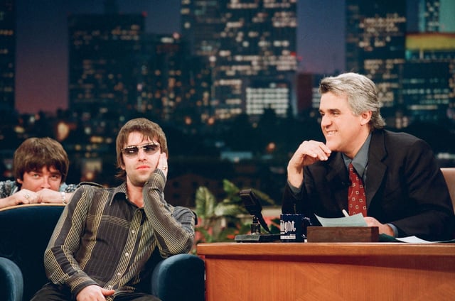 Liam, with Noel over his shoulder, during a 1998 appearance on "The Tonight Show" with Jay Leno. The band's outward indifference to celebrity made them an anomaly in the American pop culture landscape.