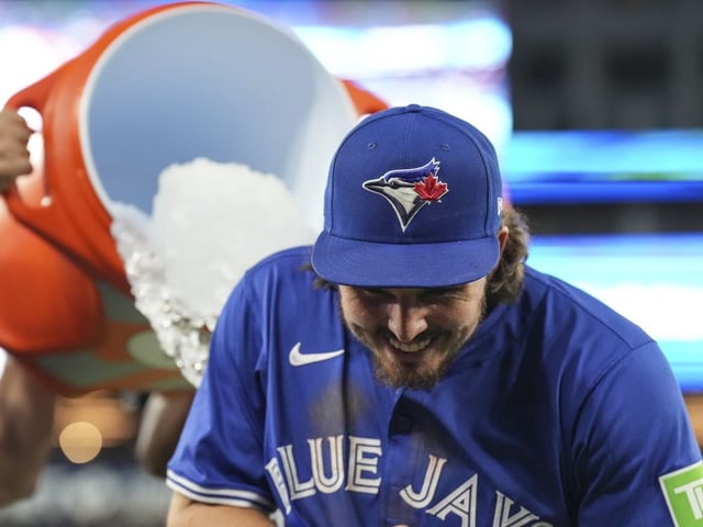 Toronto Blue Jays' Addison Barger ducks away from an ice bucket thrown by teammates after defeating the Minnesota Twins in MLB baseball action in Toronto on Wednesday, August 27, 2025.