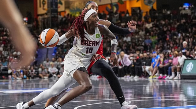 Aug 27, 2025; College Park, Georgia, USA; Atlanta Dream guard Rhyne Howard (10) dribbles against Las Vegas Aces center A'ja Wilson (22) during the second half at Gateway Center Arena at College Park. Mandatory Credit: Dale Zanine-Imagn Images
