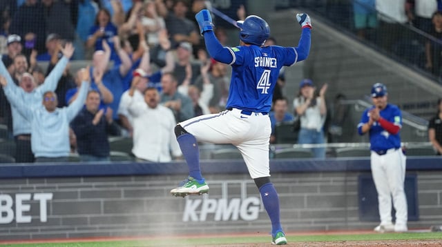 Aug 27, 2025; Toronto, Ontario, CAN; Toronto Blue Jays designated hitter George Springer (4) celebrates after sliding into home plate and scoring a run against the Minnesota Twins during the ninth inning at Rogers Centre. Mandatory Credit: Nick Turchiaro-Imagn Images