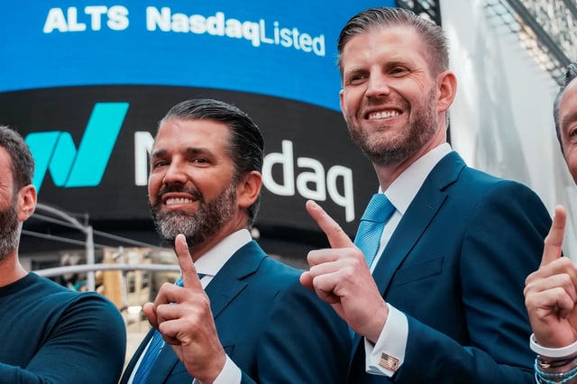 Donald Trump Jr. and Eric Trump gesture outside the Nasdaq building after ringing the opening bell to celebrate the closing of ALT5’s $1.5 billion offering and adoption of its $WLFI Treasury Strategy at the Nasdaq Market, in New York City, U.S., August 13, 2025.  REUTERS/Eduardo Munoz/File Photo