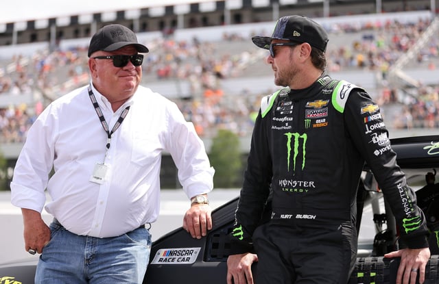 Kurt Busch, driver of the #1 Monster Energy Chevrolet, and team owner Chip Ganassi talk on the grid prior to the NASCAR Cup Series Pocono Organics CBD 325 at Pocono Raceway on June 26, 2021 in Long Pond, Pennsylvania.