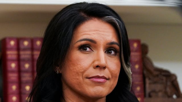 Tulsi Gabbard looks on during her swearing in ceremony as Director of National Intelligence, in the Oval Office at the White House in Washington, D.C., U.S., February 12, 2025. REUTERS/Nathan Howard