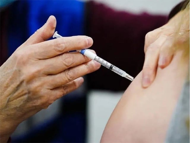 A health worker administers a dose of a vaccine during a clinic.