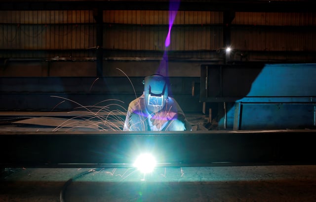 A labourer welds an iron pillar at a building material factory in an industrial area in Dasna, in the central Indian state of Uttar Pradesh, India, January 9, 2019. Picture taken January 9, 2019. REUTERS/Adnan Abidi/File Photo