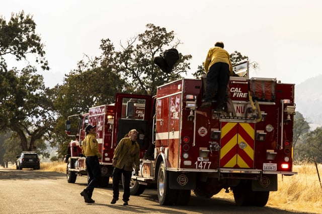 Cal Fire crews prepare their engine as they move to engage the Pickett Fire in Pope Valley on Friday, Aug. 22.