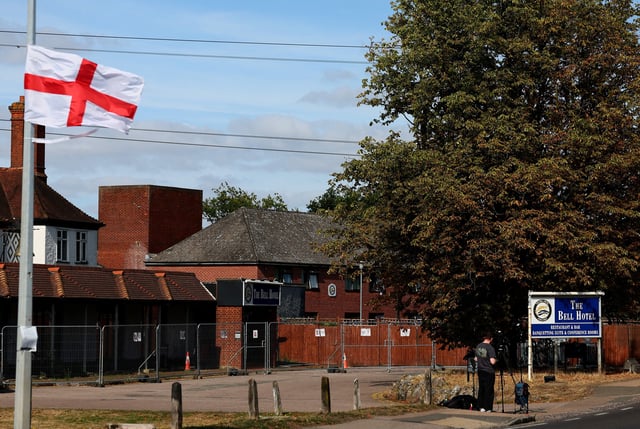 Media reports outside The Bell Hotel, following Tuesday's High Court ruling in London that granted a temporary injunction to stop asylum seekers from being housed at the site, in Epping, Britain, August 20, 2025. REUTERS/Isabel Infantes/File Photo
