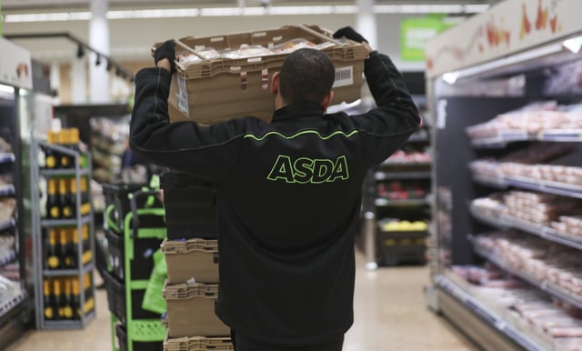 An employee stocks shelves at the Asda superstore in High Wycombe, Britain, February 8, 2017.  REUTERS/Eddie Keogh/File Photo