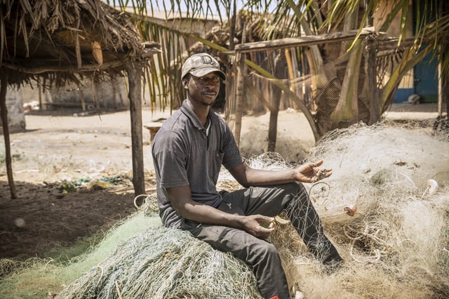 Fisherman Salif Nudure shows some of his unusable nets damaged by trawlers, at Gunjur, Gambia, on March 23, 2025. (AP Photo/Grace Ekpu)