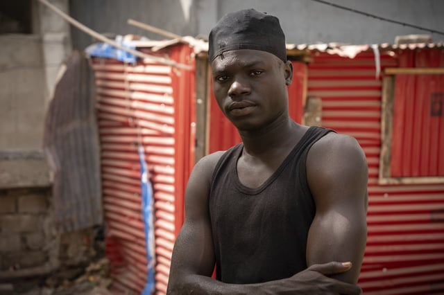 Kawsu Leigh, a fisherman who was injured in a seabound arson attack, stands for a portrait at his home in Banjul, Gambia, on March 25, 2025, almost a year after an attack on the foreign-owned vessel Abu Islam where he was working. (AP Photo/Grace Ekpu)