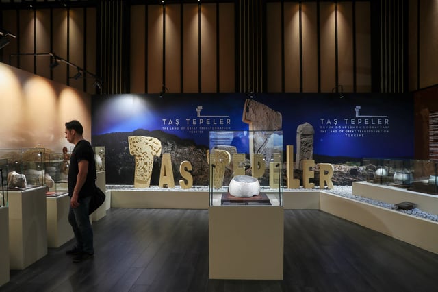 A visitor looks at animal sculptures, discovered at the Karahan Tepe archaeological site, as he visits the "Golden Age of Archaeology" exhibition at the Presidential Complex Exhibition Hall in Ankara, Turkey, August 21, 2025. REUTERS/Cagla Gurdogan
