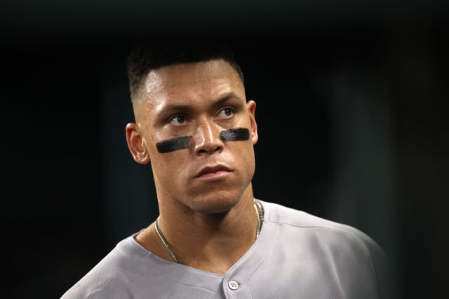 ARLINGTON, TEXAS - AUGUST 05: Aaron Judge #99 of the New York Yankees walks in the dugout during the ninth inning against the Texas Rangers at Globe Life Field on August 05, 2025 in Arlington, Texas. (Photo by Tim Heitman/Getty Images)
