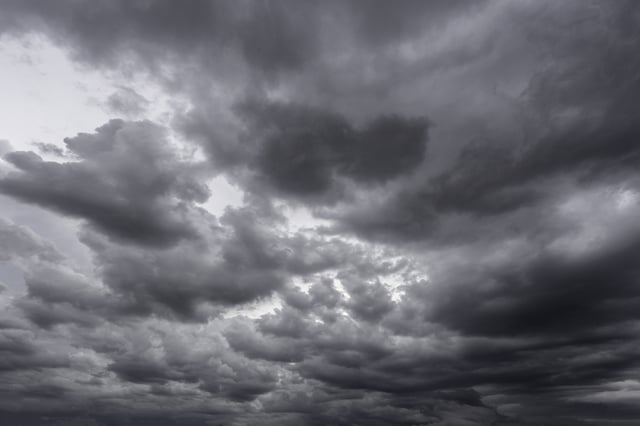 Full frame of a low angle shot of a gray sky with clouds of rain.