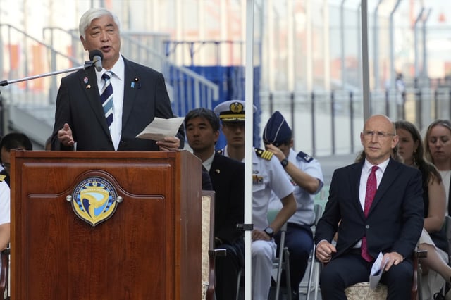 Japan's Defense Minister Gen Nakatani, left, delivers a speech as Britain's Secretary of State for Defence John Healey attends a welcome ceremony for the Royal Navy aircraft carrier HMS Prince of Wales during its port call in Tokyo Thursday, Aug. 28, 2025. (AP Photo/Eugene Hoshiko)