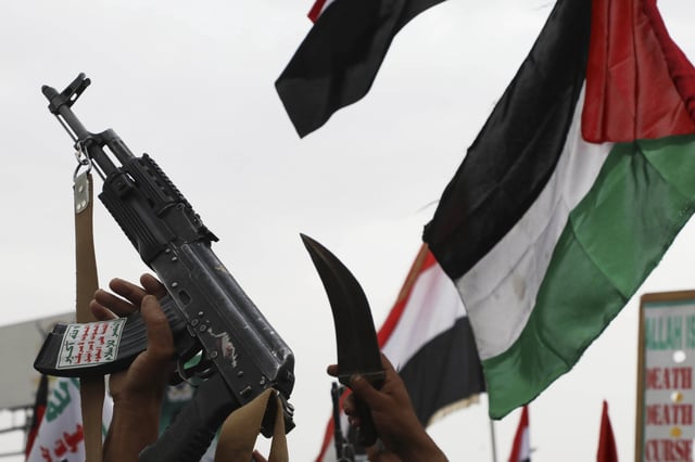 Houthi supporters shout slogans during an anti-U.S. and anti-Israel weekly rally as they raise a Palestinian flag in Sanaa, Yemen, Friday, July 4, 2025.