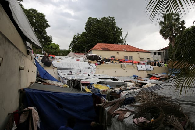 General view of people standing at a shelter at the Church of Jesus Christ of Latter-Day Saints, which houses individuals displaced by gang violence, in Port-au-Prince, Haiti, June 12, 2025. REUTERS/Jean Feguens Regala/File Photo