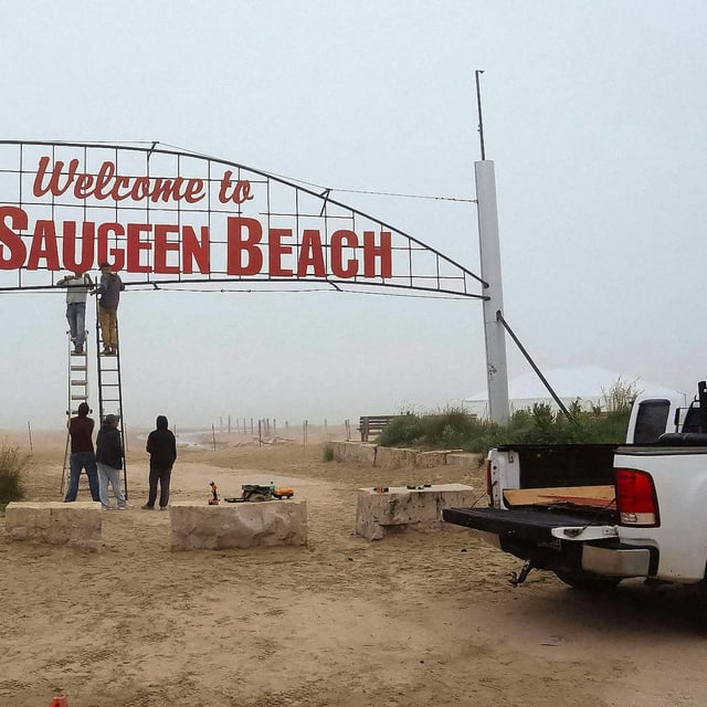 Saugeen First Nation members work on changing the lettering of the former Sauble Beach welcome sign, updated to reflect the re-allocation of the land to the First Nations community, on Tuesday, July 1, 2025. THE CANADIAN PRESS/Handout -  Cheree Urscheler (Mandatory Credit)