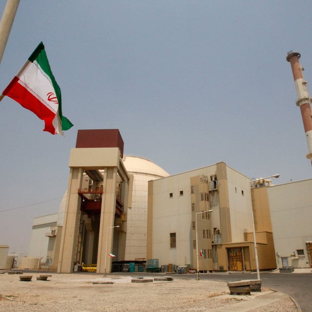An Iranian flag in front of the reactor building at the Bushehr nuclear power plant in Iran in 2010. Britain, France and Germany launched a process to reimpose UN sanctions on Iran over its nuclear program on Thursday.