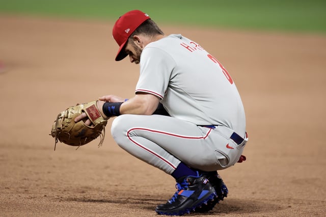 NEW YORK, NEW YORK - AUGUST 25: Bryce Harper #3 of the Philadelphia Phillies kneels down between the eighth and ninth inning against the New York Mets at Citi Field on August 25, 2025 in New York City.