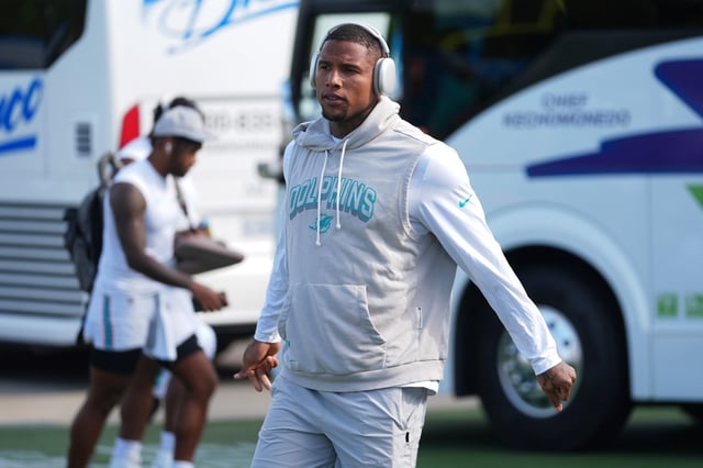 Miami Dolphins tight end Darren Waller stretches during a joint NFL football training camp with the Detroit Lions Wednesday, Aug. 13, 2025, in Allen Park, Mich. (AP Photo/Ryan Sun)