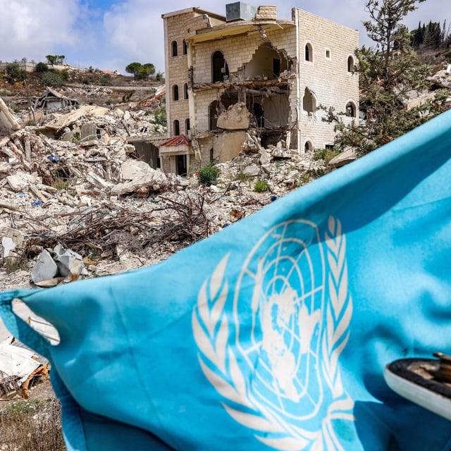 TOPSHOT - A United Nations flag flies from an armoured vehicle of the UN Interim Force in Lebanon (UNIFIL) during a patrol near destroyed buildings in the village of Kfar Kila in southern Lebanon near the border with northern Israel on August 27, 2025. (Photo by ANWAR AMRO / AFP) (Photo by ANWAR AMRO/AFP via Getty Images)