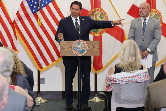 Florida Gov. Ron DeSantis points to Florida CFO Blaise Ingoglia as they both announce issuing “investigative subpoenas” to Orange County employees during a press conference in Orlando on Wednesday, Aug. 27, 2025. The subpoenas are to search for information that may have been hidden or deleted by the employees during a DOGE audit. (Stephen M. Dowell/Orlando Sentinel)