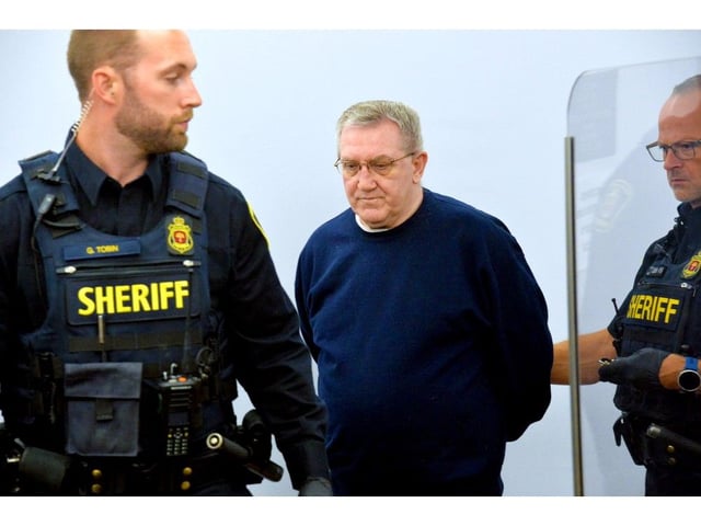 Tony Humby is led into court at the start of his trial Aug. 27, 2025.