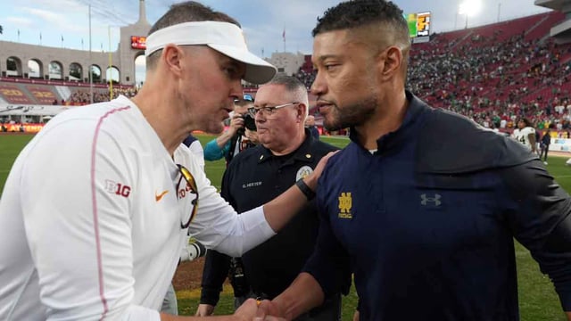 Nov 30, 2024; Los Angeles, California, USA; Southern California Trojans head coach Lincoln Riley and Notre Dame Fighting Irish head coach Marcus Freeman shake hands after the game at United Airlines Field at Los Angeles Memorial Coliseum. Mandatory Credit: Kirby Lee-Imagn Images