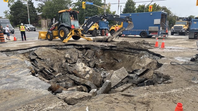 A large sinkhole closed a Toronto's Coxwell Avenue and Cosburn Avenue after a water main break Wednesday night.