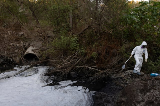 Ryan Duffy, a San Diego State University graduate student, collects water samples from the Tijuana River on Tuesday, Sept. 10, 2024. (Ana Ramirez / The San Diego Union-Tribune)