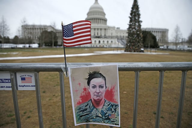 A picture of Ashli Bobbitt hangs near the Capitol on Jan. 6, 2022.