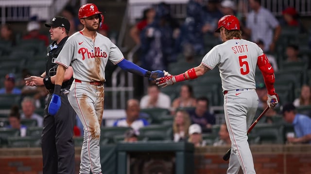 Jun 27, 2025; Atlanta, Georgia, USA; Philadelphia Phillies shortstop Trea Turner (7) celebrates with second baseman Bryson Stott (5) after scoring a run against the Atlanta Braves in the first inning at Truist Park. Mandatory Credit: Brett Davis-Imagn Images