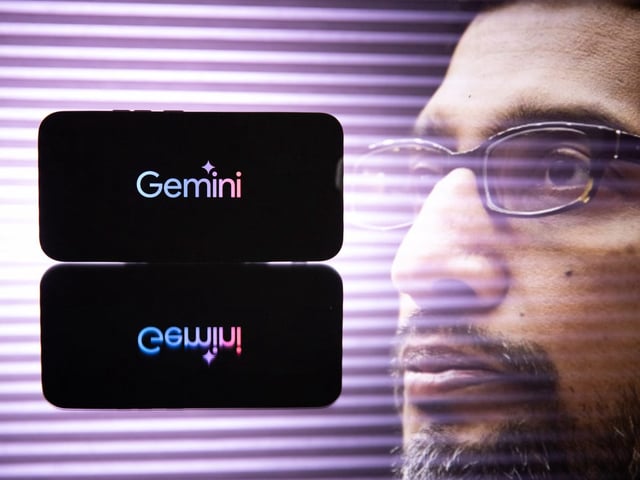 A phone displaying the Gemini logo alongside Google CEO Sundar Pichai