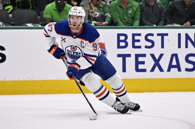 May 23, 2025; Dallas, Texas, USA; Edmonton Oilers center Connor McDavid (97) skates with the puck against the Dallas Stars in the first period for game two of the Western Conference Final of the 2025 Stanley Cup Playoffs at American Airlines Center. Mandatory Credit: Jerome Miron-Imagn Images