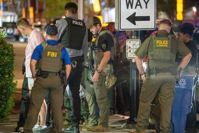 FBI and Border Patrol officers arrest a man, after he assaulted law enforcement with a sandwich, along the U Street corridor during a federal law enforcement deployment to the nation's capital on Aug. 10, 2025 in Washington.