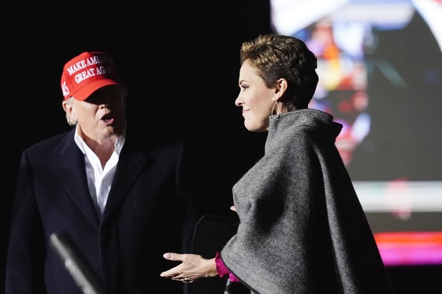 Donald Trump, left, introduces Kari Lake, right, as Trump speaks at a rally on Jan. 15, 2022, in Florence, Ariz.