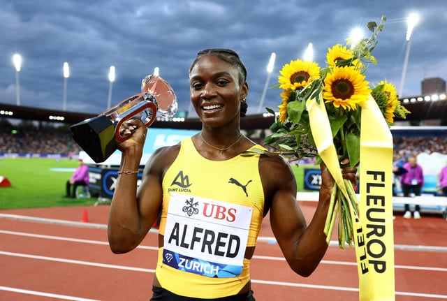 Athletics - Diamond League - Final - Zurich - Letzigrund, Zurich, Switzerland - August 28, 2025 Saint Lucia's Julien Alfred celebrates with a trophy after winning the Women's 100m Final REUTERS/Denis Balibouse