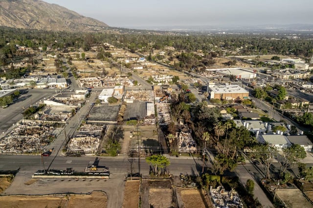 An aerial view of surviving structures and cleared lots taken in June in Altadena, where the Eaton Fire burned through several months earlier.