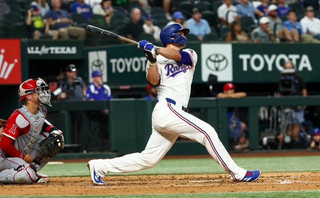 Aug 27, 2025; Arlington, Texas, USA;  Texas Rangers shortstop Corey Seager (5) hits a two-run home run during the fourth inning against the Los Angeles Angels at Globe Life Field. Mandatory Credit: Kevin Jairaj-Imagn Images/File Photo