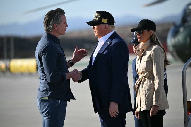 President Donald Trump followed by First Lady Melania Trump, can be seen shaking hands with California Governor Gavin Newsom upon arrival at Los Angeles International Airport in Los Angeles, California, on January 24, 2025, to visit the region devastated by the Palisades and Eaton fires. (Photo by Mandel NGAN / AFP) (Photo by MANDEL NGAN/AFP via Getty Images)