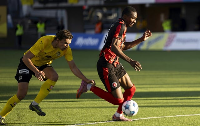 KuPS Kuopio defender Arttu Lotjonen, who was later sent off, makes a grab at Midtjylland's Denil Castillo whose Danish team won 2-0 in Finland to advance 6-0 on aggregate in their Europa League playoff