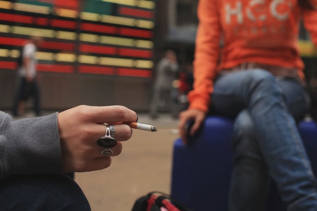 Women smoke in a Times Square pedestrian island.