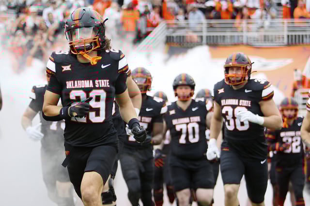 Safety Cooper Lai #29 of the Oklahoma State Cowboys runs onto the field for a game against the Arizona State Sun Devils at Boone Pickens Stadium on November 2, 2024 in Stillwater, Oklahoma. Arizona State won 42-21.